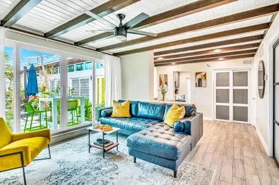 a living room with a blue couch and a table at Waterfront Heated pool Lime Key Two in Fort Lauderdale