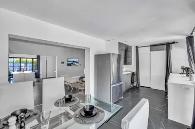 a kitchen and dining room with a glass table at Family Vacation Home in Miami