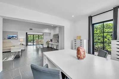 a kitchen and living room with a table and chairs at Family Vacation Home in Miami