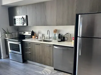 a kitchen with a stainless steel refrigerator and a sink at Luxe Ventures Miami in Miami