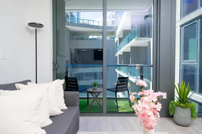 a living room with a couch and a balcony at Luxe Ventures Miami in Miami