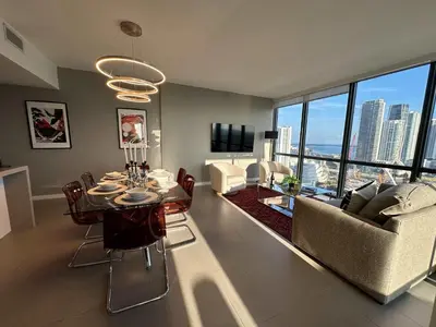 a living room with a dining table and a couch at Luxury 2BR Skyline Balcony Free Parking by Palermo Home Miami in Miami