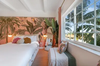 a bedroom with a bed and a large window at Le Particulier Miami in Miami Beach