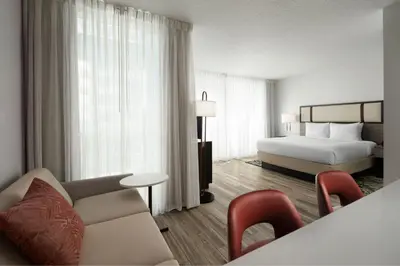 a hotel room with a bed and a couch at Residence Inn by Marriott Miami Beach Surfside in Miami Beach