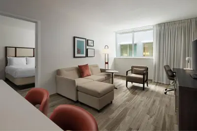 a hotel room with a couch and a bed at Residence Inn by Marriott Miami Beach Surfside in Miami Beach