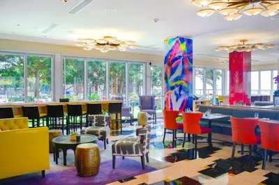 a lobby with colorful chairs and tables and a bar at Apartment on the Highest Floor - Icon Brickell 3 in Miami