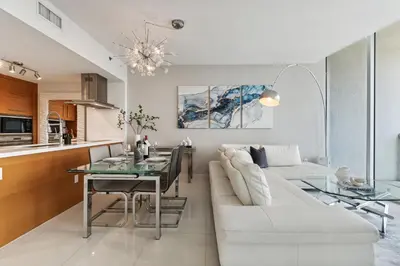a living room with a white couch and a table at Apartment on the Highest Floor - Icon Brickell 3 in Miami