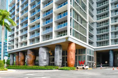 a large white building with large objects on it at Apartment on the Highest Floor - Icon Brickell 3 in Miami