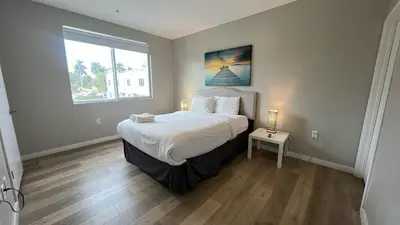a bedroom with a large bed and a window at Family Comfort Near Top Spots-Relaxing Stay for Everyone in Golden Glades