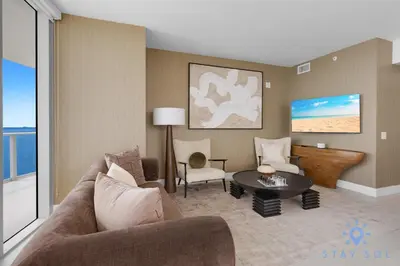 a living room with a couch and a table at Beachfront Balcony Apartment Amenities in Hollywood