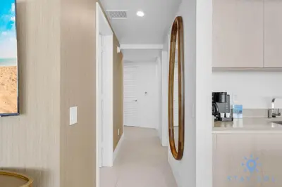 a kitchen with a sink and a mirror on the wall at Beachfront Balcony Apartment Amenities in Hollywood