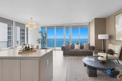 a kitchen and living room with a view of the ocean at Beachfront Balcony Apartment Amenities in Hollywood