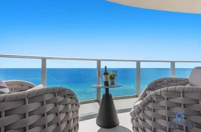 a room with two chairs and a view of the ocean at Beachfront Balcony Apartment Amenities in Hollywood