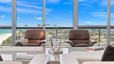 two chairs in a room with a view of the ocean at The Setai Miami Private Luxury Residences in Miami Beach