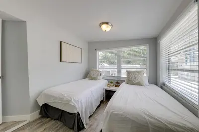 two beds in a room with a window at Unique 2 House Rental 3 Mi to Beach and Boardwalk in Hollywood