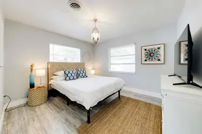 a bedroom with a bed and a flat screen tv at Unique 2 House Rental 3 Mi to Beach and Boardwalk in Hollywood