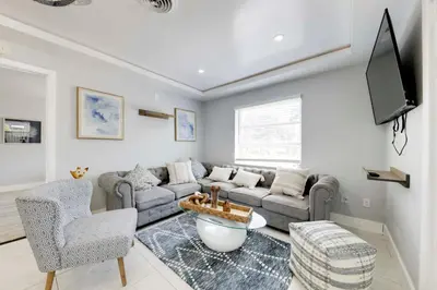 a living room with a couch and a tv at Unique 2 House Rental 3 Mi to Beach and Boardwalk in Hollywood