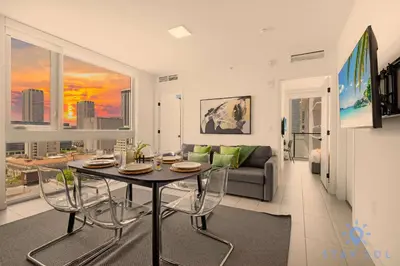 a living room with a table and a couch at Beautiful 2BR Apartment with gym and Pool in Miami