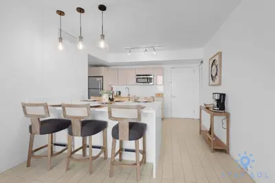 a kitchen with a table and some chairs in a room at Amazing 1BR Apt View & Balcony - Pool & Gym in Hallandale Beach