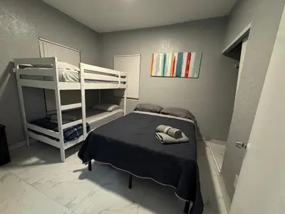 a bedroom with a bunk bed and a ladder at Belle Vista in Miami