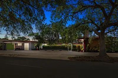 a house with a tree on the side of a street at 1BR Pet-Friendly Studio Parking & Backyard BBQ in Hollywood