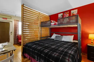 a bedroom with a bunk bed and red walls at 1BR Pet-Friendly Studio Parking & Backyard BBQ in Hollywood