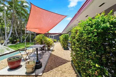 a patio with a table and a red umbrella at Modern 1BR Studio in Hollywood | Free Parking in Hollywood