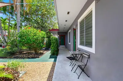 a porch of a house with chairs and plants at Bright 2BR Getaway | BBQ, Garden & Parking in Hollywood