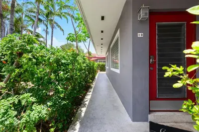 a hallway of a house with a red door at Bright 2BR Getaway | BBQ, Garden & Parking in Hollywood