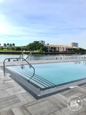 a swimming pool with a metal handrail and water at 3 BDR Beach Bliss in Hollywood