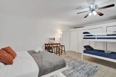a bedroom with a bed and a ceiling fan at Central Stunning Villa with Heated Pool Cabana in Hollywood Ridge Farms