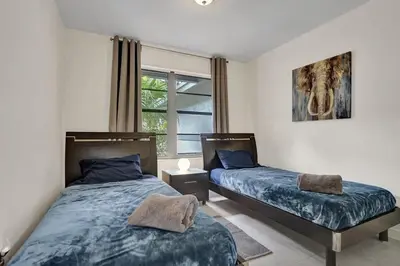 a bedroom with two beds and a window at Central Stunning Villa with Heated Pool Cabana in Hollywood Ridge Farms