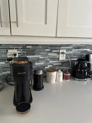 a kitchen counter with a coffee maker on the counter at Charming two Bedroom in the Gables For Rent in Miami