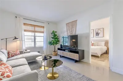 a living room with a couch and a tv and a bed at Contemporary chic, next to the beach - 1 Bedroom in Miami Beach
