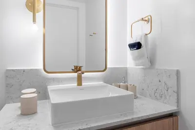 a bathroom with a white sink and a mirror at Downtown Miami 2BR-2BA Panoramic City Views in Miami