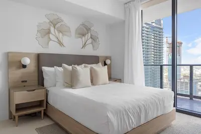 a bedroom with a bed and a large window at Downtown Miami 2BR-2BA Panoramic City Views in Miami