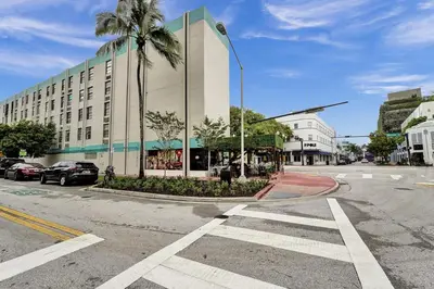 an empty street with a building and a palm tree at Ocean Dr 1BR • Miami Beach Getaway in Miami Beach