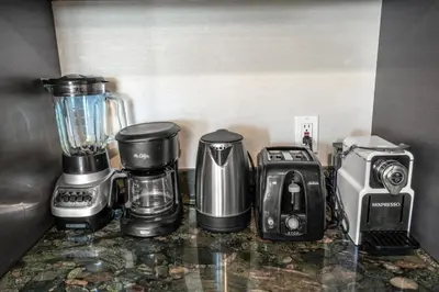 a counter with a blender and other appliances on it at Icon Brickell Gem 2-BR Oasis with Amazing Views in Miami