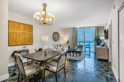 a dining room and living room with a table and chairs at Icon Brickell Gem 2-BR Oasis with Amazing Views in Miami