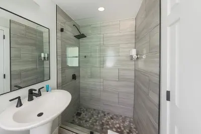 a bathroom with a white sink and a shower at Dania Beach 1BR | Steps to Ocean + Parking in Dania Beach