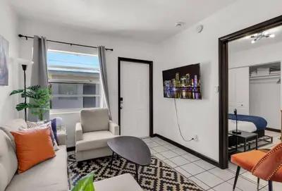 a living room with a couch and a chair at Triplex with 3 Bedrooms, 6 Min/Beach+Free Parking in Dania Beach