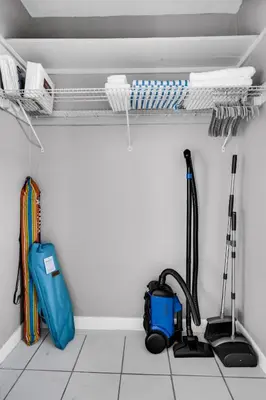 a room with two vacuum cleaners and a suitcase at Chic 1BR Getaway Near FLL Airport + 6 MN to Ocean in Dania Beach