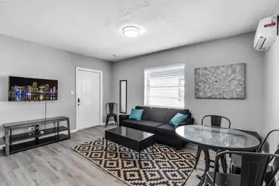 a living room with a couch and a table at Chic 1BR Getaway Near FLL Airport + 6 MN to Ocean in Dania Beach