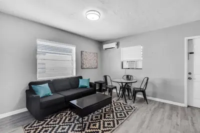 a living room with a couch and a table at Chic 1BR Getaway Near FLL Airport + 6 MN to Ocean in Dania Beach