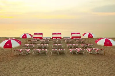 a group of chairs and umbrellas on a beach at W South Beach 1B Residence Ocean View in Miami Beach