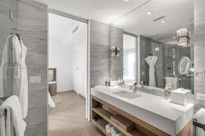 a bathroom with a sink and a large mirror at W South Beach 1B Residence Ocean View in Miami Beach