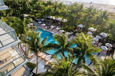 an aerial view of a resort with a pool and palm trees at W South Beach 1B Residence Ocean View in Miami Beach
