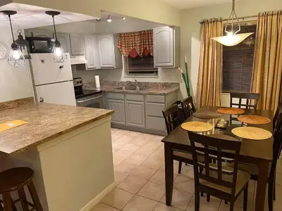 a kitchen and dining room with a table and chairs at Econoroom Hollywood in Hollywood