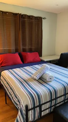 a bed with two pillows on it in a room at Econoroom Hollywood in Hollywood