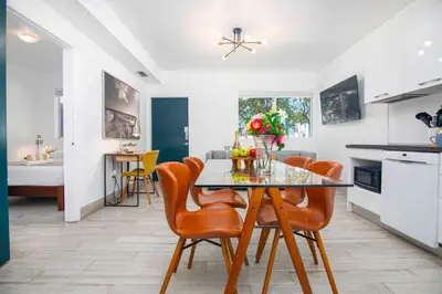 a kitchen and dining room with a table and chairs at Boutique Apartments SoBe in Miami Beach